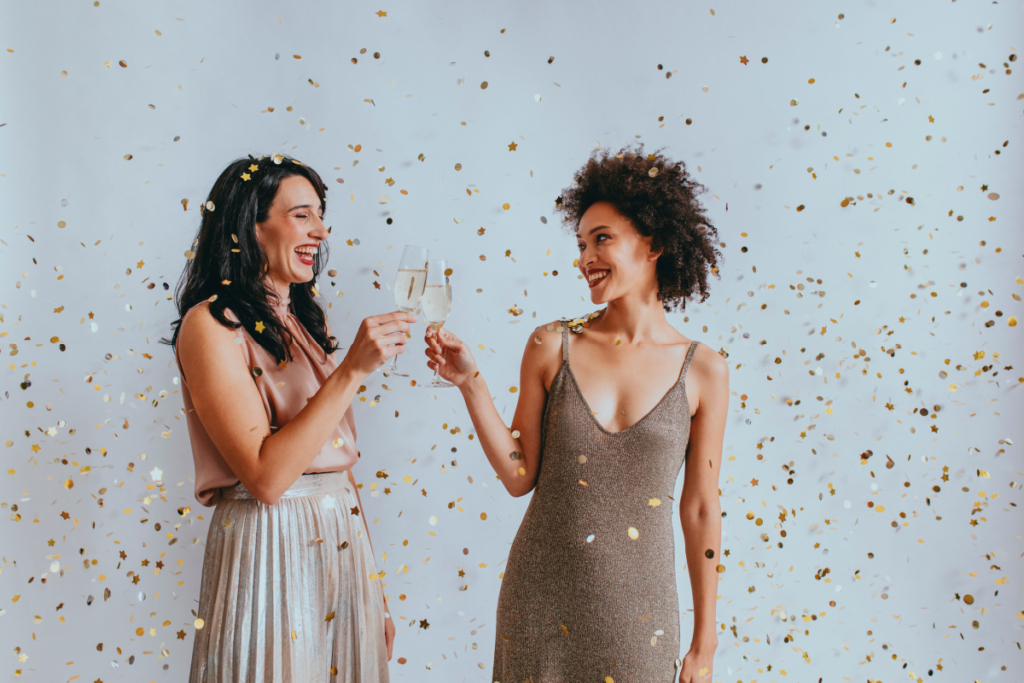 Two women dressed up and drinking champagne at fun open house event